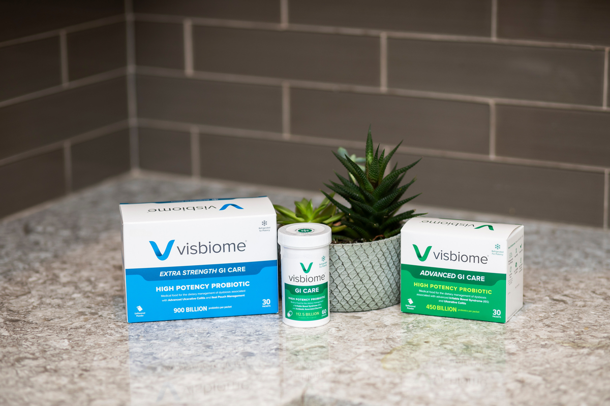 Visbiome probiotic products on a countertop with a plant in the background.